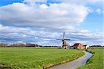 sunny day on Dutch farmland with windmill, Holland