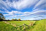 blue sky over fence on sunny dutch farmland, Holland