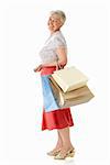 Elderly woman with shopping bags on white background