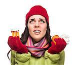 Sick Mixed Race Woman Wearing Winter Hat and Gloves with a Tissue Holding Empty Medicine Bottle Isolated on White.