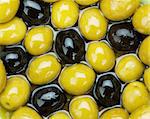 Green and black olives texture food background