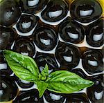 Black olives in olive oil and basil
