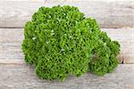 Curly parsley on  wooden table