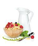 Fresh corn flakes with berries and milk jug. Isolated on white background