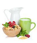 Fresh corn flakes with berries, milk jug and cup. Isolated on white background