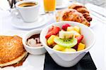 Breakfast with coffee and croissants on table