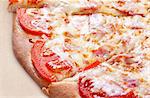 Delicious italian pizza with ham, tomato and cheese