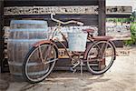 Old Rusty Antique Bicycle and Wine Barrel in a Rustic Outdoor Setting.