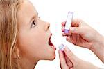 Young girl taking granules of homeopathic medication - closeup