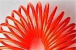 Orange red spiral plastic air hose used for pneumatic tools.
