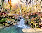 Cascade mountain river in a forest in autumn