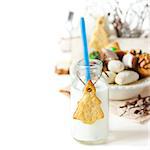 Christmas tree cookies and milk on a white background.