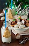 Sweet cookies and milk for Santa on a white background.