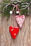 Christmas decoration with two hearts on an old wooden background.