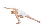 Full length of a sporty young woman practicing yoga over white background