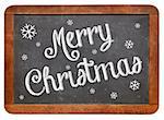 Merry Christmas - white chalk text  on a vintage slate blackboard