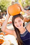 Preteen Girl Portrait at the Pumpkin Patch in a Rustic Setting.