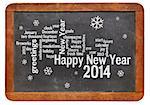 Happy New Year 2014 word cloud - white chalk text  on a vintage slate blackboard