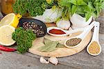 Herbs and spices on cutting board and wood table