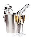 Champagne bottle in bucket, two glasses and alarm clock. Isolated on white background