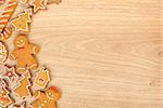 Homemade various christmas gingerbread cookies on wooden background with copy space