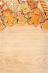 Homemade various christmas gingerbread cookies on wooden background with copy space