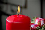 Detail shot of advent wreath burning red candle