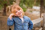 Cute Smiling Young Girl Posing for a Portrait Outside.