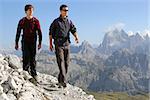 Young men hiking in the mountains Alps Italy