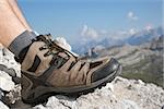 Hiking boots of a hiker while taking a rest in the mountains