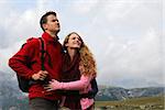 Young couple on holidays in the mountains on a hiking tour