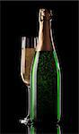 Glass and bottle of champagne on a black background