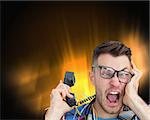 Composite image of frustrated computer engineer screaming while on call on black glowing background