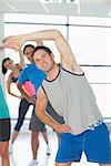 Portrait of sporty people doing power fitness exercise at yoga class