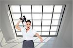 Composite image of angry businesswoman throwing binoculars away while posing
