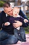 Adorable Infant Boy and Young Military Father Play Together in the Park.