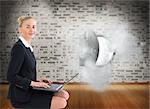 Composite image of blonde businesswoman using laptop