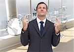 Composite image of serious businessman with fingers crossed is looking up