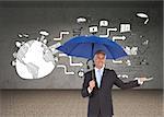 Composite image of peaceful businessman holding blue umbrella