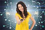 Composite image of smiling curly haired pretty woman changing channel with remote