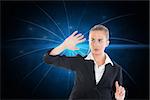 Composite image of blonde businesswoman pointing somewhere