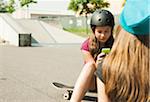 Girls using Cell Phone in Skatepark, Feudenheim, Mannheim, Baden-Wurttemberg, Germany