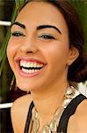 Portrait of young woman, smiling wearing circle necklace