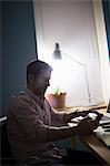 Man sitting at desk using smartphone
