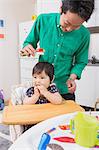 Father combing baby's hair