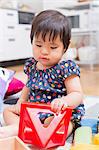 Baby girl playing on floor