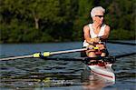 Senior woman rowing in rowing boat