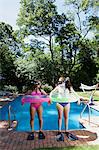 Friends playing by pool