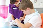 Dental patient practicing flossing on dentures