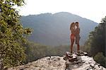 Young couple kissing on rock ledge, Hamburg, Pennsylvania, USA